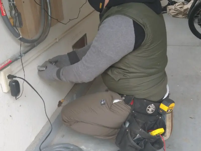 Electrician performing outlet wiring in a Eagle garage